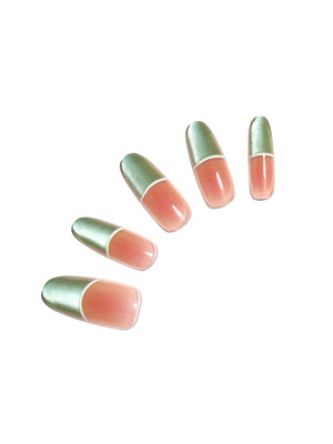 Green and gold French tip oval press-on nails with nude base on white background