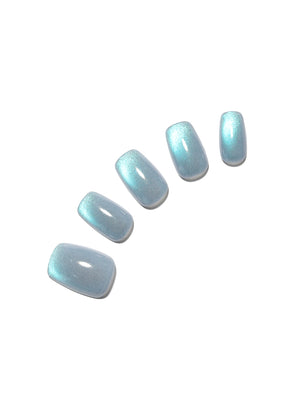 Set of light blue cat-eye nail polish on a white background