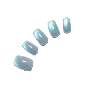 Set of light blue cat-eye nail polish on a white background