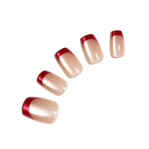 Red French tip press-on nails with nude base and metallic red tips