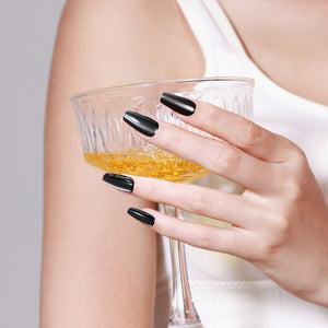Both hands showing Wild Rock medium coffin black press-on nails