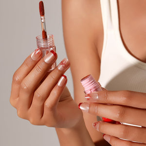 Red French tip press on nails with bow nail art on nude shimmer base
