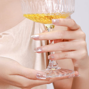 Hand wearing Snowy Wishes white winter glitter press on nails for holiday look