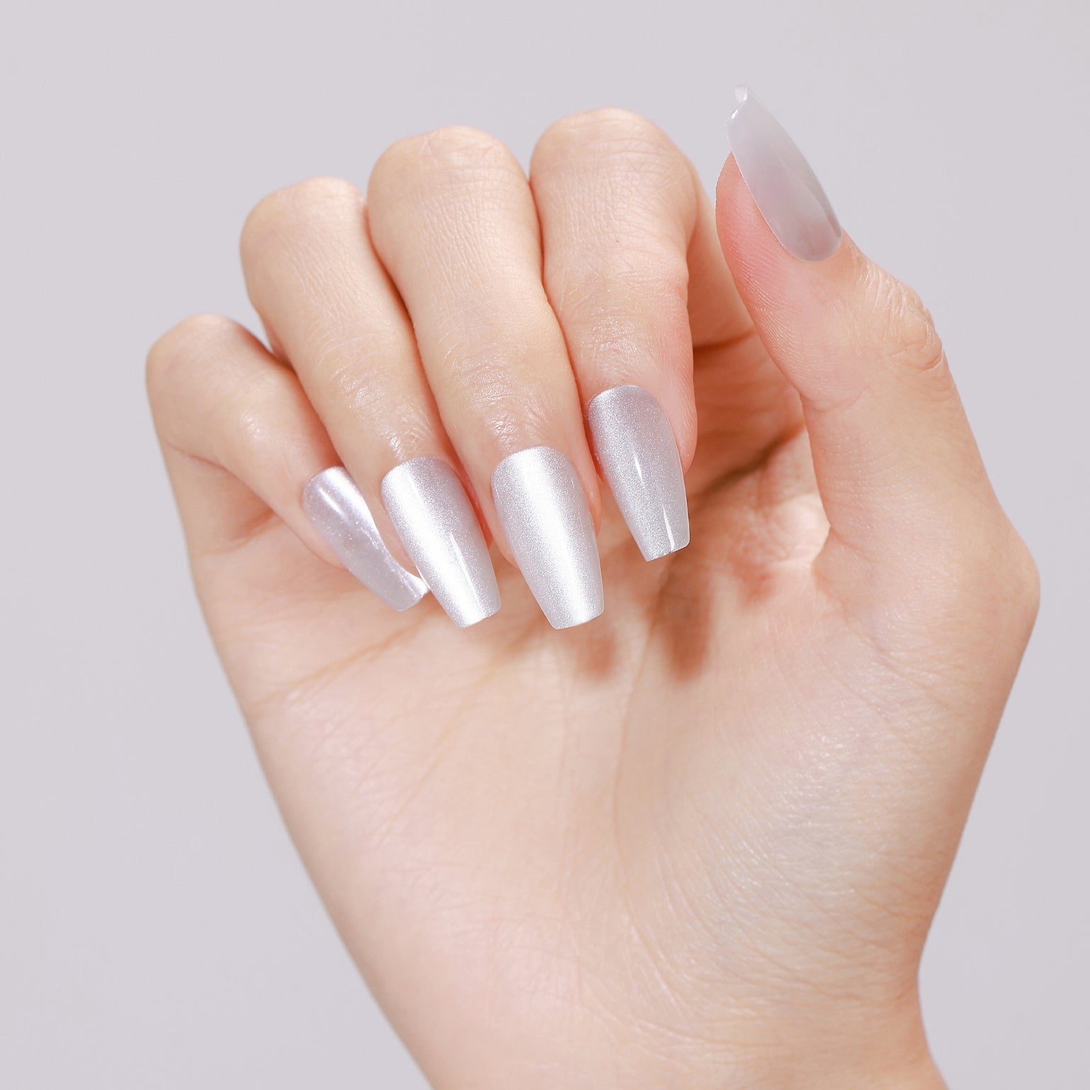 Hand wearing Ice Cold long coffin icy silver white shimmer press-on nails