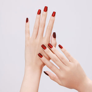 Hand wearing Drama Queen matte red square press on nails for bold night-out look