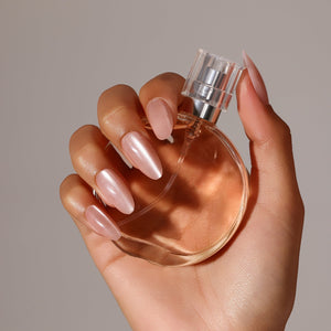 Hand wearing Silk Blush medium almond blush pink press-on nails clean luxe manicure