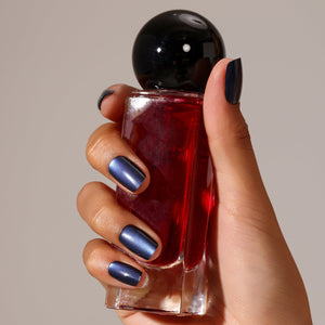 Hand wearing Galaxy navy metallic short square press-on nails chrome shimmer manicure