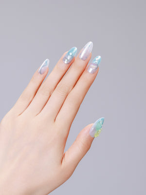 Hands wearing Jellyfish Dreams long almond clear jelly nails with aqua swirls and pearl accents