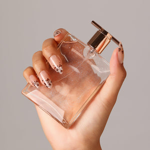 Hand wearing Glitter Cheetah nude leopard tip press-on nails medium almond glossy manicure
