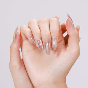 Hands wearing Mirror Dust long almond mirror chrome press-on nails with rainbow shift