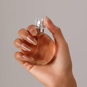 Close-up Sunlit Nude nude and gold shimmer ombre long oval press-on nails glossy finish