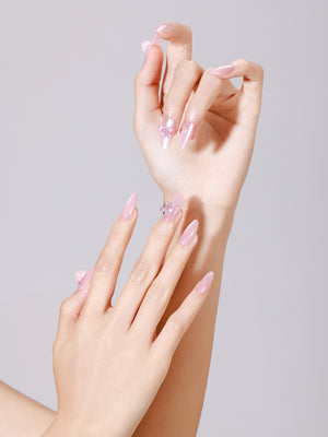 Hand wearing Silk Butterfly long almond glazed pink press-on nails with 3D butterfly accent nail