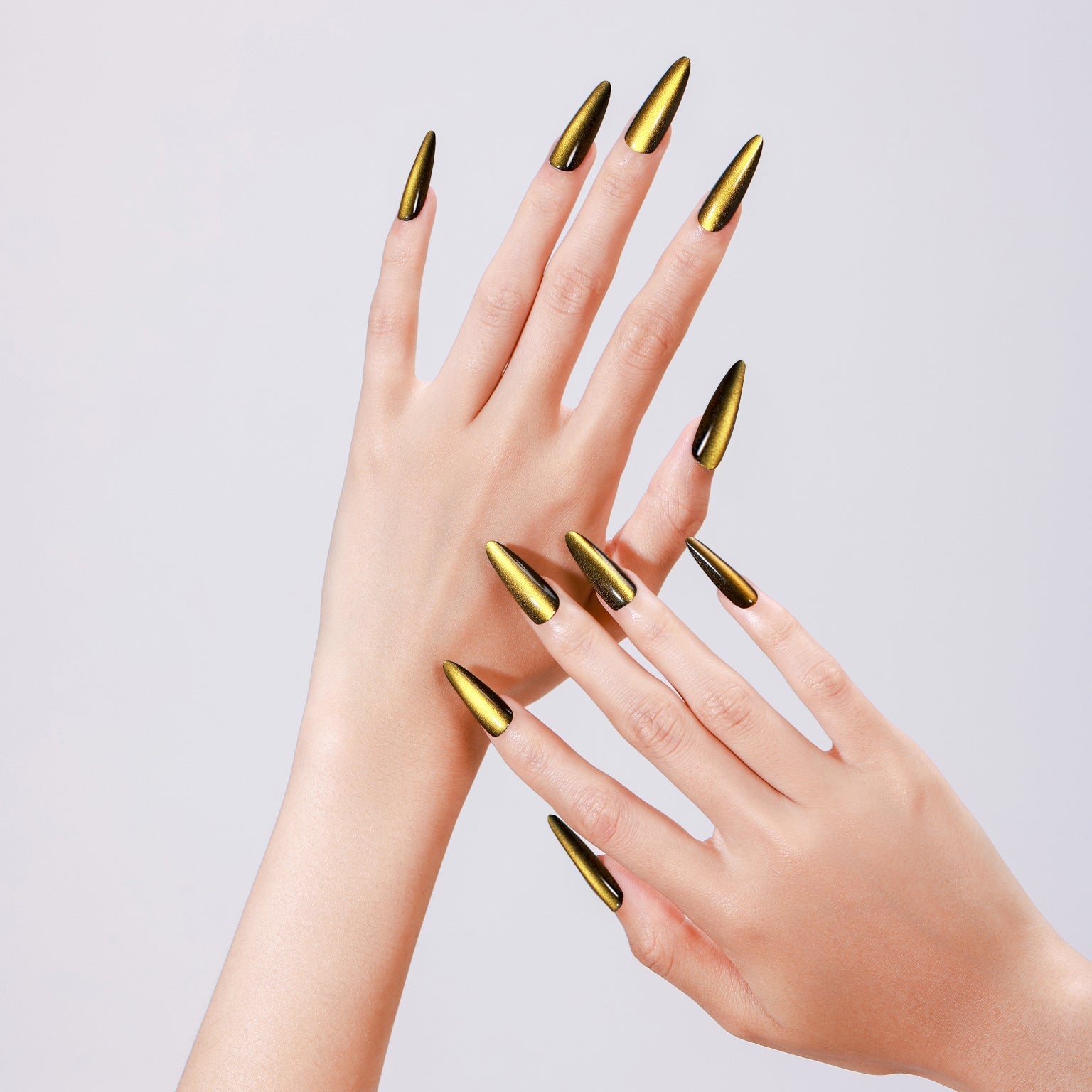 Hand wearing Sunlit Matcha long stiletto gold green chrome press-on nails glossy metallic finish