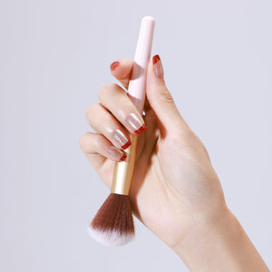 Close up of Fortune Spark nude press on nails with red French tips and gold foil accents
