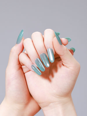 Hands wearing Glacier Teal long oval glossy teal press-on nails