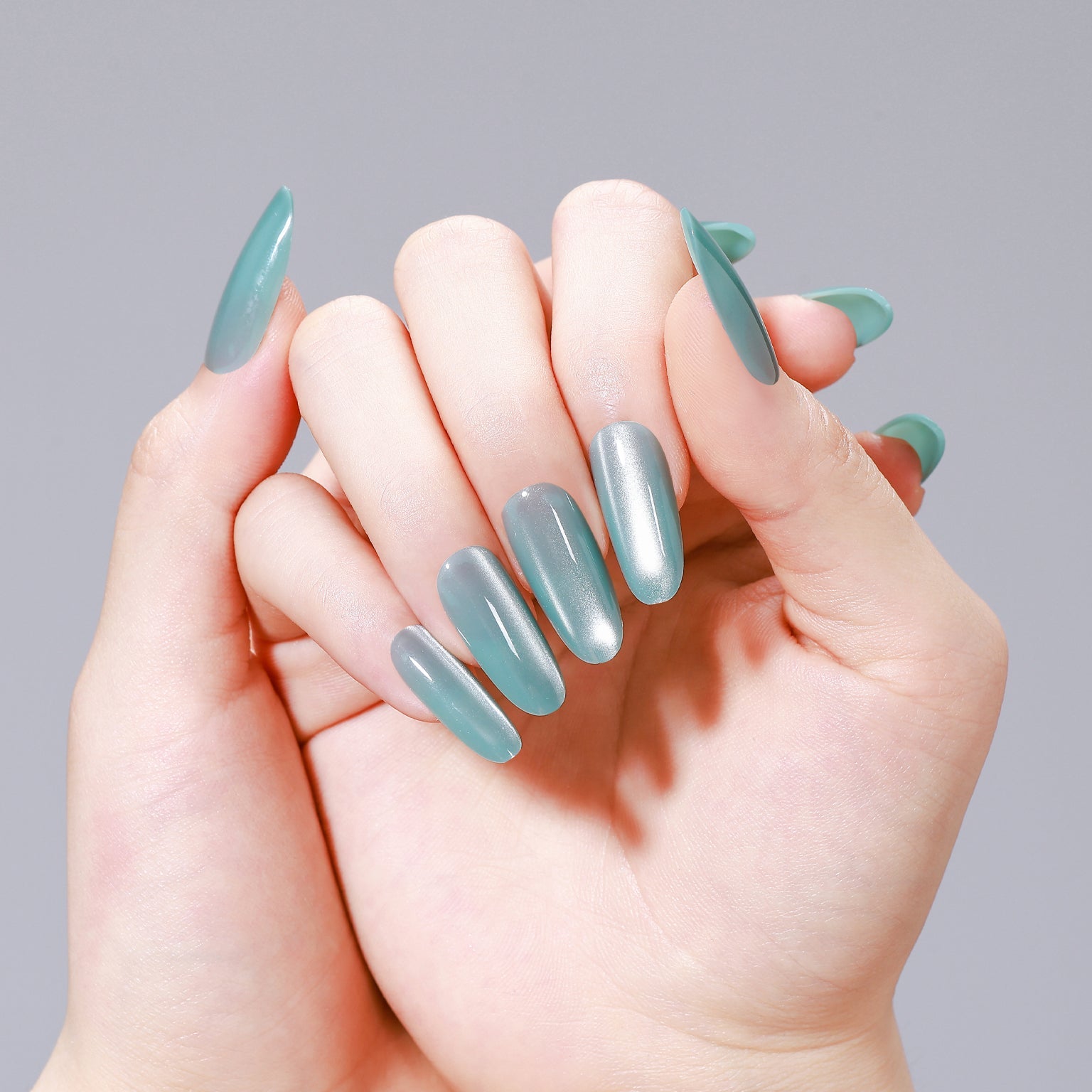 Hands wearing Glacier Teal long oval glossy teal press-on nails