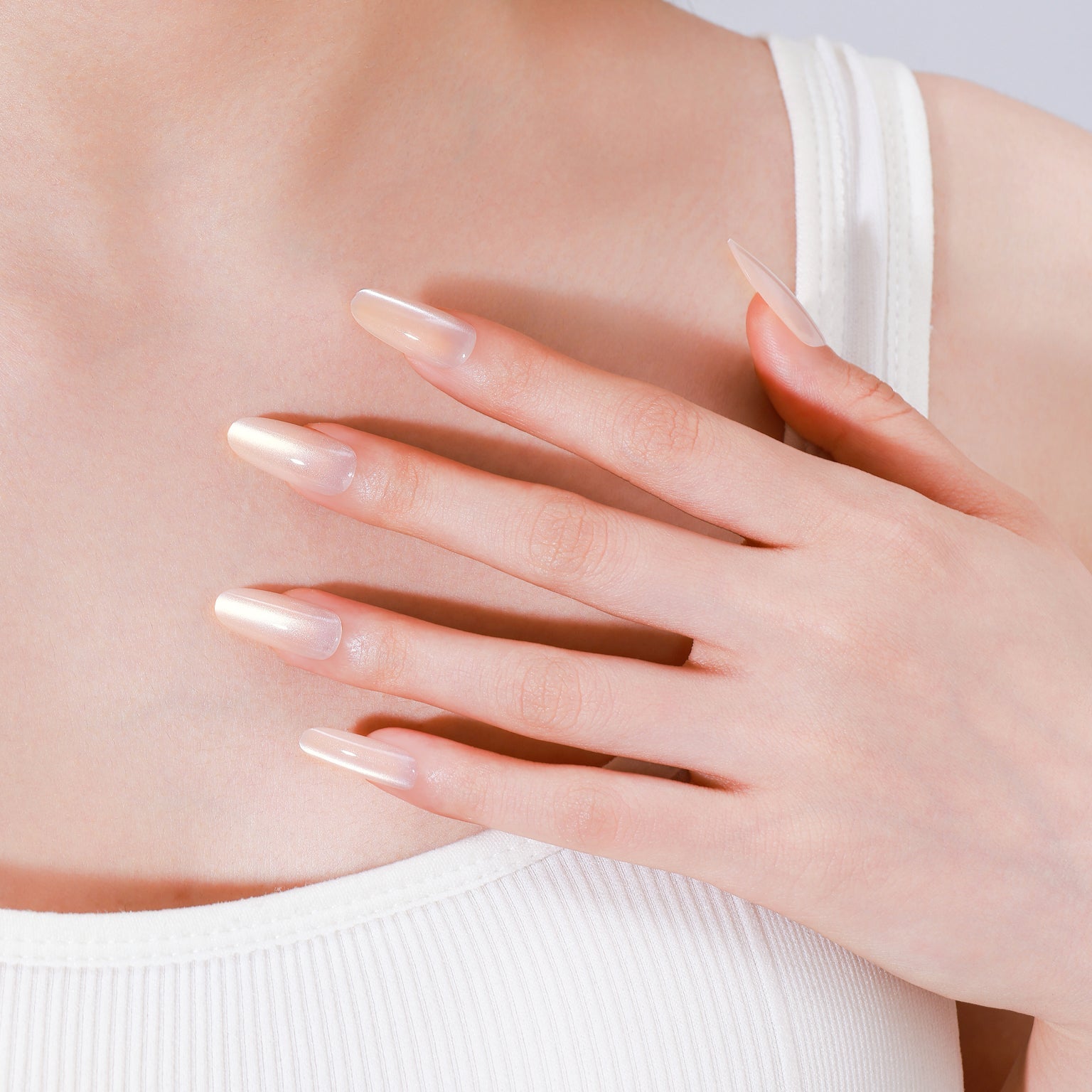 Long oval soft peach press-on nails with glossy gel finish