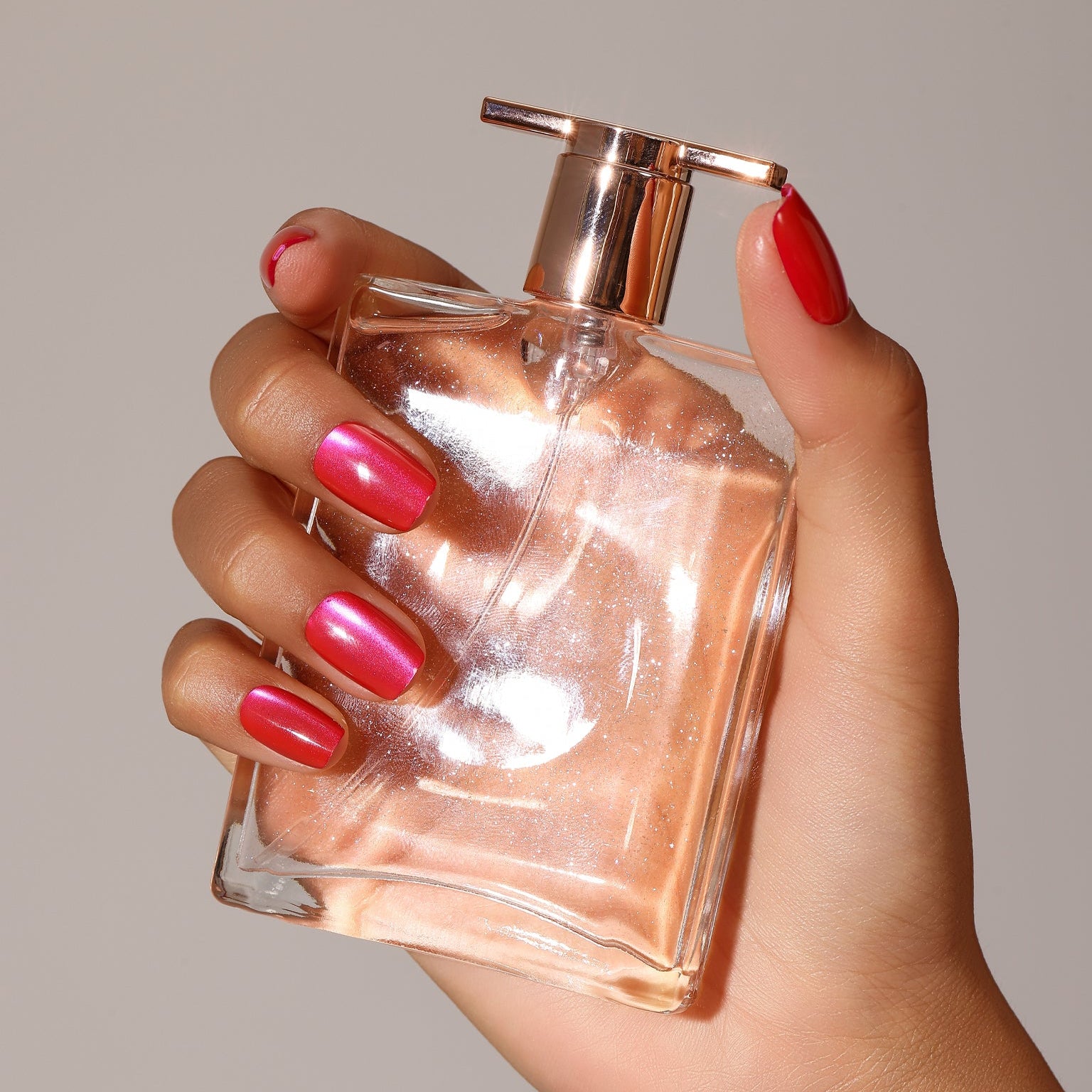 Close-up Hot Pink Rush magenta cat eye shimmer press-on nails square shape with coral red accents