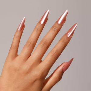 Hand wearing Pink Lady long stiletto rose chrome press-on nails mirror finish manicure