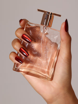 Hand wearing Flame Game metallic red coffin press on nails for bold night-out look