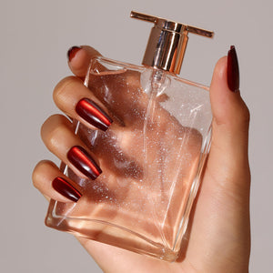 Hand wearing Flame Game metallic red coffin press on nails for bold night-out look