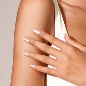 Hand wearing Minimal Muse nude pearl press-on nails square shape natural looking glossy manicure