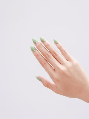 Salon-quality mint green press-on nails applied at home