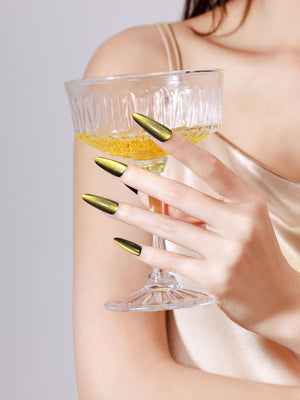 Both hands showing Sunlit Matcha long stiletto green gold chrome acrylic press-on nails