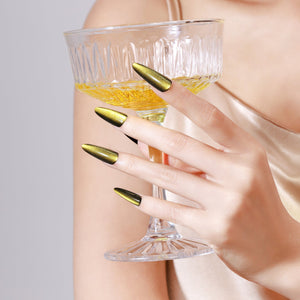 Both hands showing Sunlit Matcha long stiletto green gold chrome acrylic press-on nails