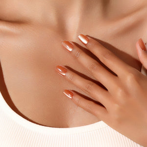 Hand wearing Citrus Squeeze copper tangerine pearl press-on nails square shape luminous manicure