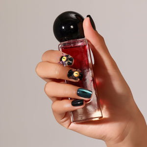 Close-up Night Watcher 3D eye charm press-on nails black manicure with yellow slit pupil detail