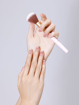 Hand wearing Nude Illusion nude French press-on nails with glossy gel finish
