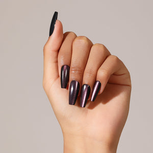 Hand wearing Eggplant dark purple long coffin press on nails with glossy finish