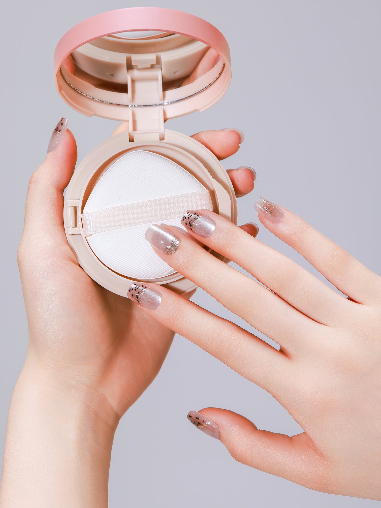 Hand wearing Cocoa Spots square press-on nails with speckled brown design