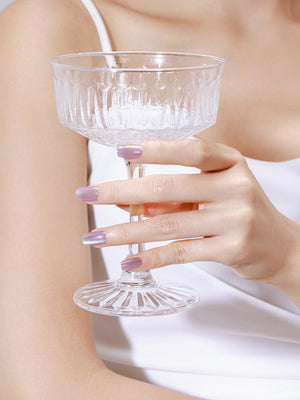 Hand wearing Hologlow holographic chrome square press on nails with rainbow glow effect