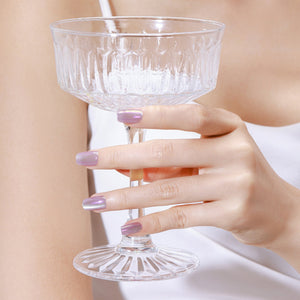 Hand wearing Hologlow holographic chrome square press on nails with rainbow glow effect