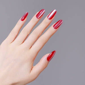 Hand wearing Rose Quartz red cat eye long oval press on nails for bold night out manicure