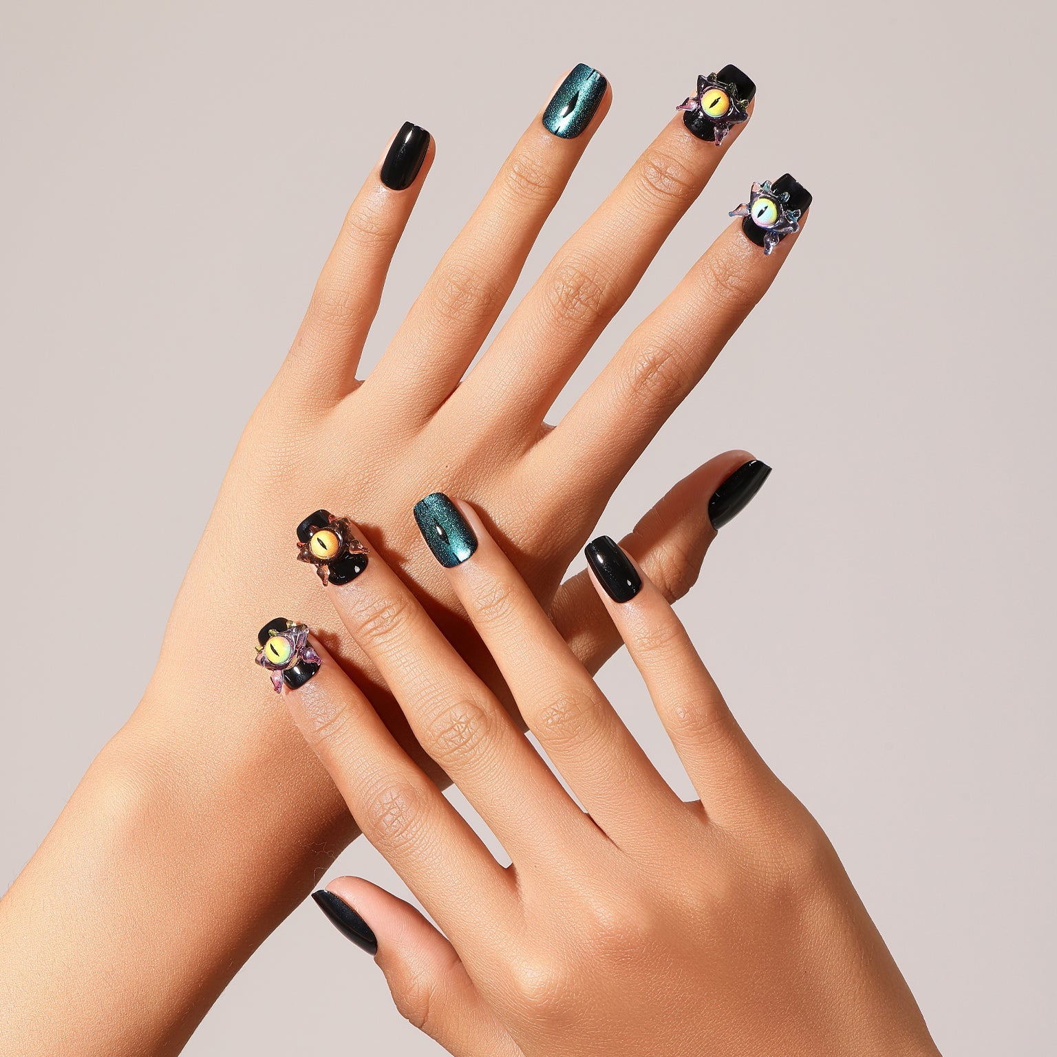 Flat lay Night Watcher press-on nails black and teal cat eye set with 3D charm accent nails