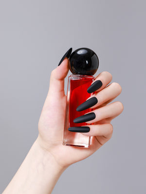 Close-up of long oval matte black PMMA acrylic press-on nails from ShadePax