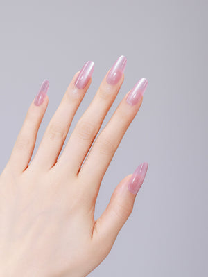 Close-up of Pink Cloud long oval pink acrylic press-on nails with salon-grade gel shine