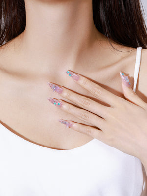 Both hands showing Star of the Tide glossy nude ocean press-on nails with iridescent sparkle