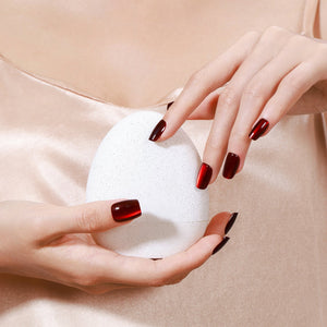 Hand wearing Cherry Flame red cat eye square press on nails for bold night out look