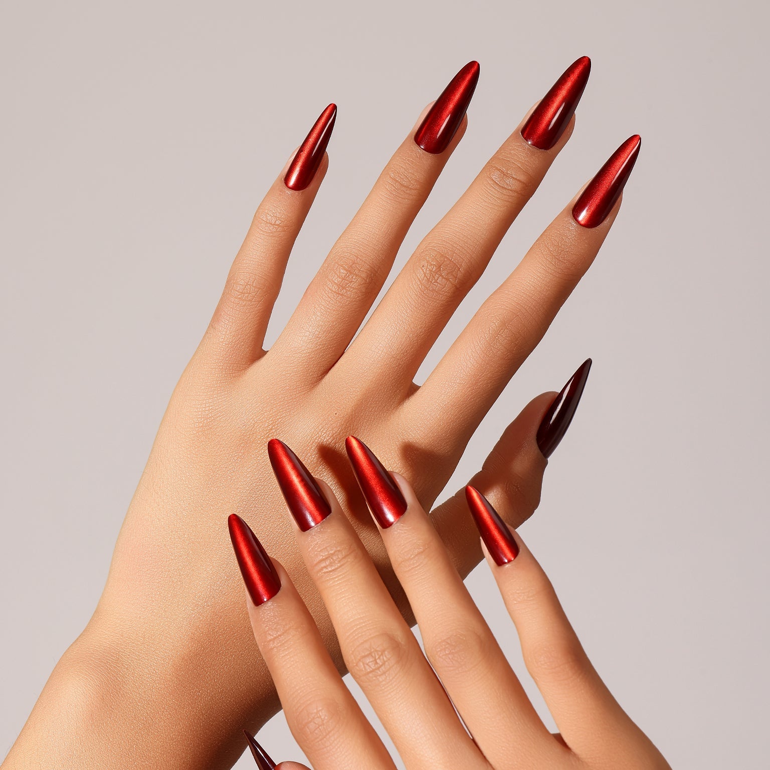 Hand wearing Ruby Rush classic ruby red almond press on nails with glossy finish