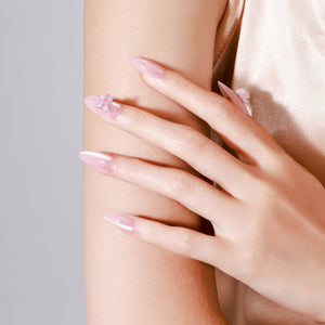 Close-up Silk Butterfly blush pink chrome press-on nails glossy pearl shine with floral charm detail