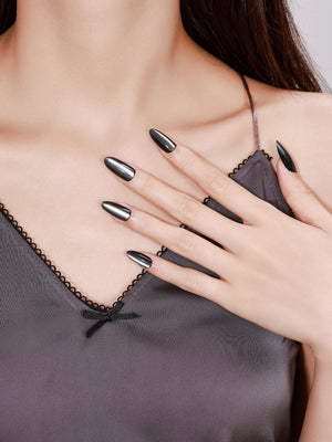 Both hands showing Noir Eclipse long almond black chrome acrylic press-on nails night-out manicure