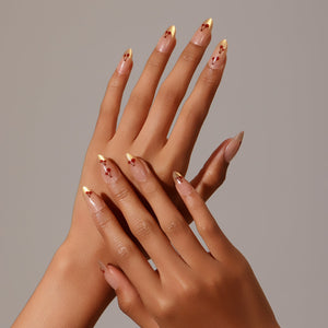 Full set showing Cherry Spark Nails nude and gold French tip press-on nails with cherry design
