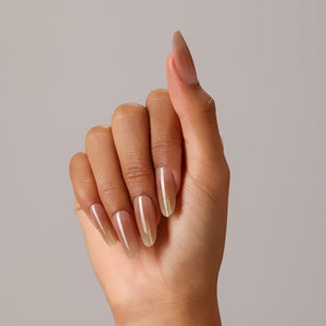 Full set showing Sunlit Nude long oval nude press-on nails with luminous gold fade