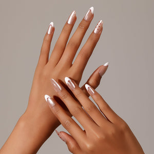Full set showing Blushing Valentine medium almond French tip press-on nails with white tips and bow accents