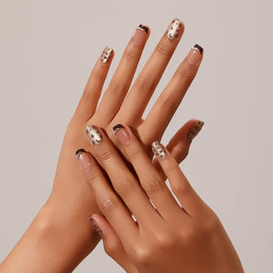 Hand wearing Cocoa Leopard short square nude nails with cocoa micro French tips and leopard accent nails