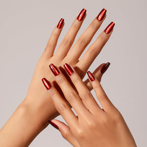 Hand wearing Flame Game metallic red coffin press on nails for bold night-out look